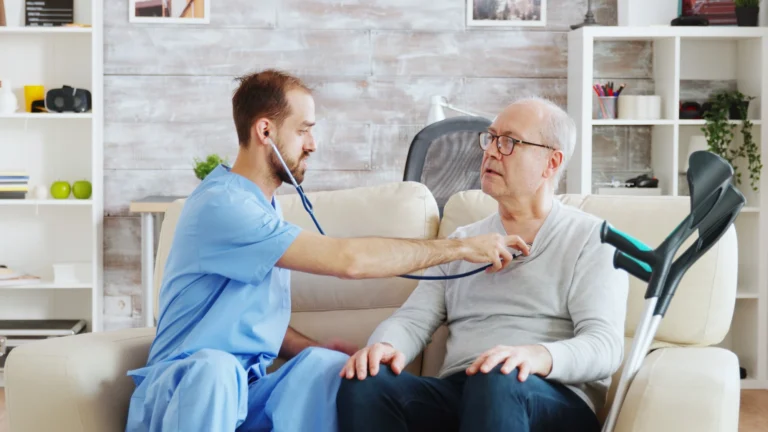 revealing-shot-young-male-nurse-listening-old-reti